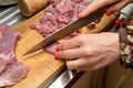Woman on a cutting board slices turkey meat into pieces
