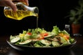 Female hand delicately drizzles a freshly prepared salad with olive oil from glass