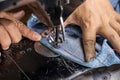 Female hand and denim with old sewing machine Royalty Free Stock Photo