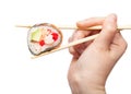 Chopsticks hold western-style sushi roll close up Royalty Free Stock Photo