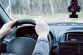 Female hand on the driving wheels. Driving a modern car steering wheel and hand close-up