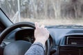 Female hand on the driving wheels. Driving a modern car steering wheel and hand close-up