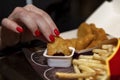 Female hand eats nuggets at mclonalds. Close-up