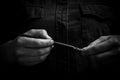 Female hand elegantly holding an ink pen with a metal tip close-up on a black background. classic fountain pen isolated macro Royalty Free Stock Photo