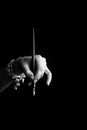 Female hand elegantly holding an ink pen with a metal tip close-up on a black background. classic fountain pen isolated macro Royalty Free Stock Photo