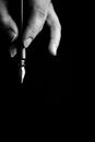 Female hand elegantly holding an ink pen with a metal tip close-up on a black background. classic fountain pen isolated macro Royalty Free Stock Photo