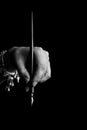 Female hand elegantly holding an ink pen with a metal tip close-up on a black background. classic fountain pen isolated macro Royalty Free Stock Photo