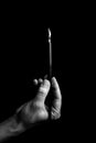 Female hand elegantly holding an ink pen with a metal tip close-up on a black background. classic fountain pen isolated macro Royalty Free Stock Photo