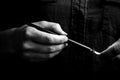 Female hand elegantly holding an ink pen with a metal tip close-up on a black background. classic fountain pen isolated macro Royalty Free Stock Photo