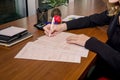 Female hand fills an Australian tax form on a table in an office.