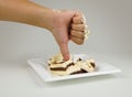 Female hand with a finger down. Thumbs down on the background of cake. Not tasty cake. Dislike cake. Concept is unlike.