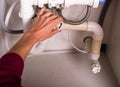 Female hand fixing plumbing Royalty Free Stock Photo