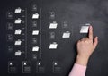 Female hand and folder over a black background with several folders and documents scattered around