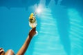 Female hand with fresh coctail, pool on background Royalty Free Stock Photo