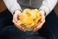 Female hand giving crispy potato chips bowl Royalty Free Stock Photo