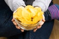 Female hand giving crispy potato chips bowl Royalty Free Stock Photo