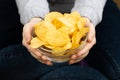 Female hand giving crispy potato chips bowl Royalty Free Stock Photo