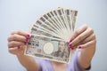 Female hand giving japanese money banknotes Royalty Free Stock Photo