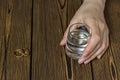 Female hand with a glass of alcohol, close-up, wooden background, copy space Royalty Free Stock Photo