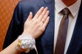 Female hand with a gold ring and manicure on the chest of a man Royalty Free Stock Photo