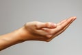 Female hand on gray background. Close up of female hand gesturing Royalty Free Stock Photo