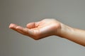 Female hand on gray background. Close up of female hand gesturing Royalty Free Stock Photo