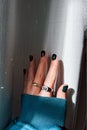 Female hand with green nail polish and stylish rings