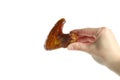 Female hand hold baked chicken wing, isolated on white background Royalty Free Stock Photo