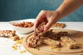 Female hand hold granola bar on background with granola bars Royalty Free Stock Photo