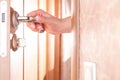 Female hand hold handle of wood door Royalty Free Stock Photo