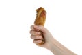 Female hand hold roast chicken drumstick, isolated on white background Royalty Free Stock Photo