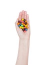 Female hand hold round color chocolate candies
