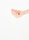 Female hand hold something, isolated on white, woman`s palm making gesture while showing small amount of something on white Royalty Free Stock Photo