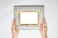 A female hand hold a wood photo frame isolated white,
