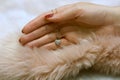 Female hand holding antique diamond heart pendant on dusty rose fur Royalty Free Stock Photo