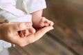 Female hand holding baby feet. Royalty Free Stock Photo