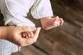 Female hand holding baby foot. Royalty Free Stock Photo