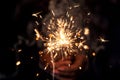 Female Hand Holding A Beautiful Burning Sparkler At Night