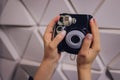 Female hand holding black instant camera close-up. Royalty Free Stock Photo