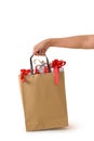 Female hand holding blank brown papaer shopping bags full of gift boxes ornamented Royalty Free Stock Photo