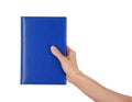 Female hand holding book with blank cover on white background