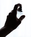 female hand holding bottle of perfume on a white backg Royalty Free Stock Photo