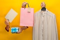 Female hand holding bright shopping bag and gifts Royalty Free Stock Photo
