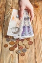 Female hand holding a British money.