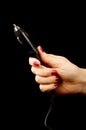 Female hand holding car cigarette lighter plug isolated Royalty Free Stock Photo