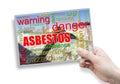 A female hand holding an card with asbestos theme Royalty Free Stock Photo