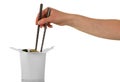 Female hand holding chopsticks pulls the noodles out of the box wok Royalty Free Stock Photo