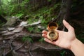 Female hand holding compass. Tracking in the mountains. Royalty Free Stock Photo