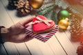 Female hand holding a cookie and gift Royalty Free Stock Photo