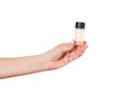 Female hand holding cream bottle of lotion isolated. Girl give tube cosmetic products on white background Royalty Free Stock Photo